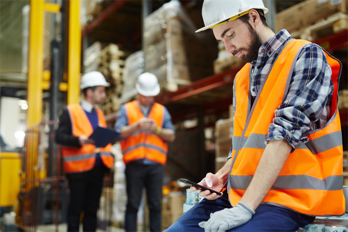 Warehouse employee looking at a mobile device