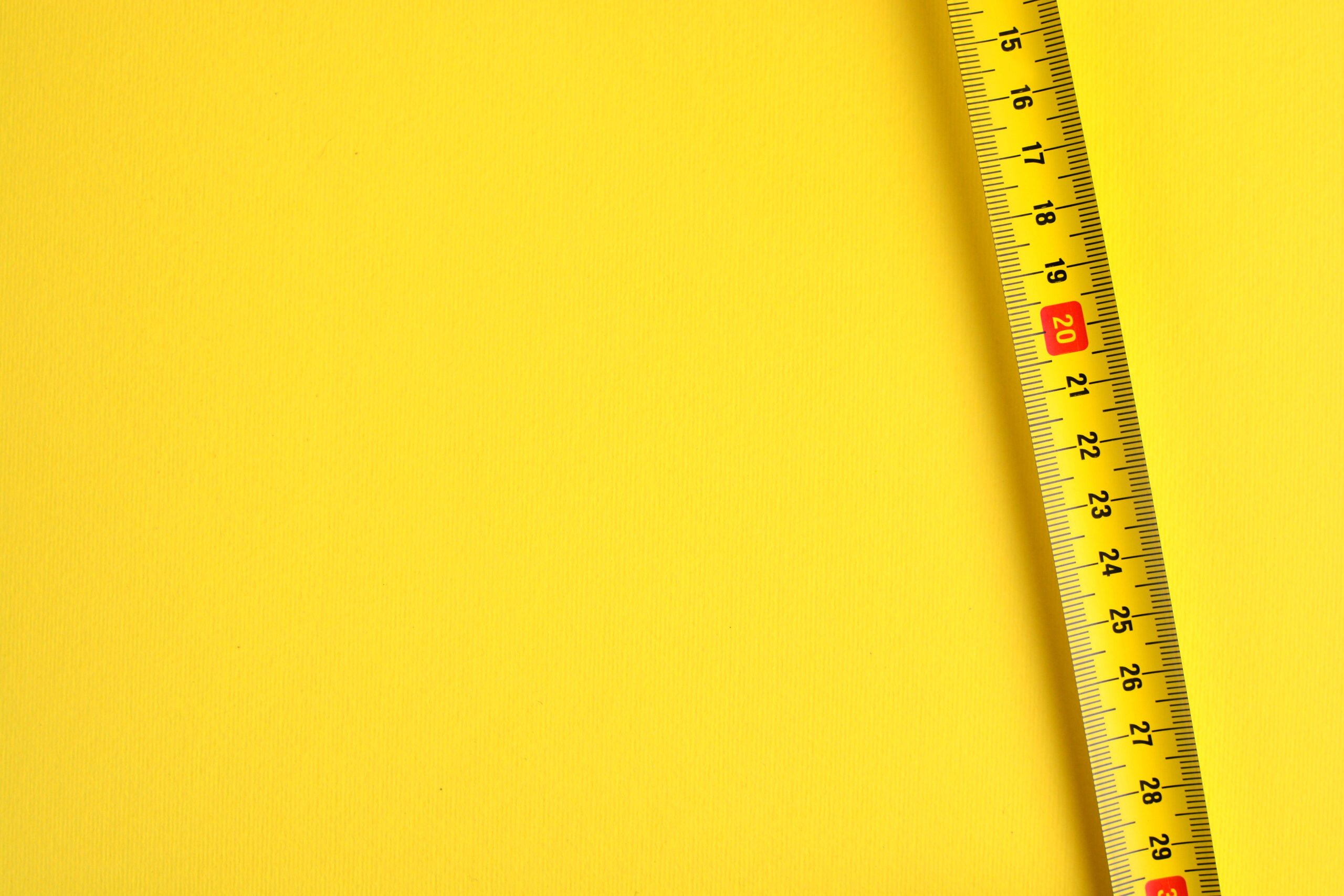 Tape measure scale on a yellow background. 