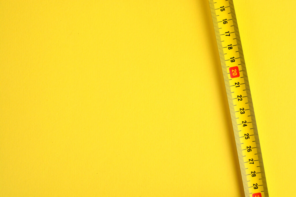 Tape Measure Scale On A Yellow Background.