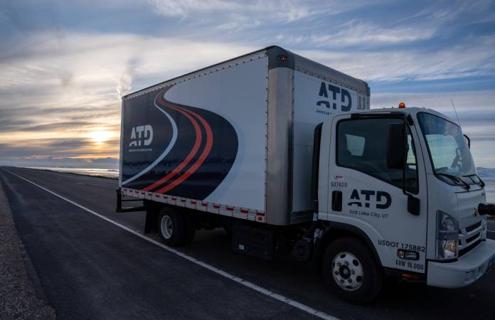 An ATD truck driving down a scenic highway