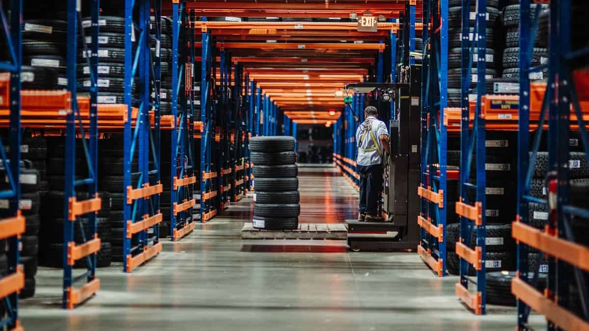 A forklift driver moving tires in the ATD warehouse