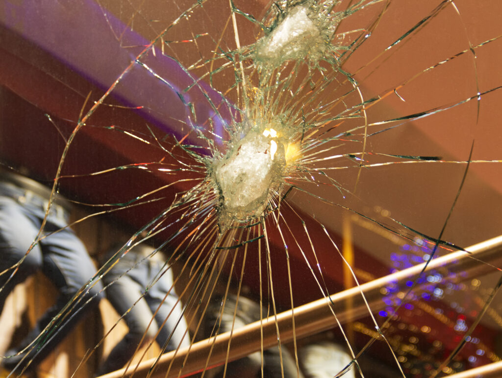 Broken window in retail store indicating workplace violence