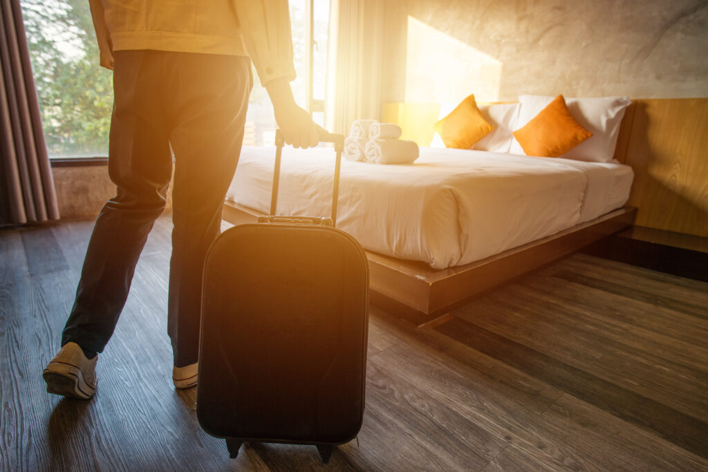 Cropped Shot Of Tourist Woman Pulling Her Luggage To Her Hotel Bedroom After Check In.