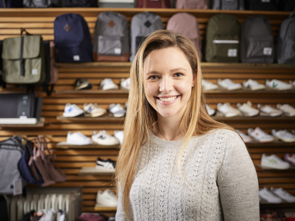 How To Use Ai To Create Unforgettable Customer Service - Retail Store Employee Smiling