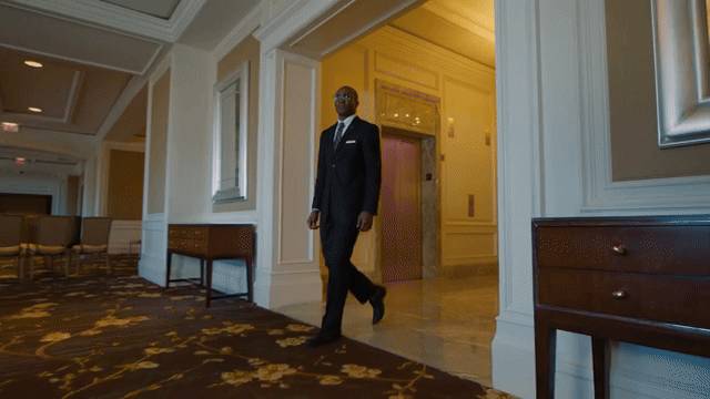 A hotel manager walking through the lobby of a hotel