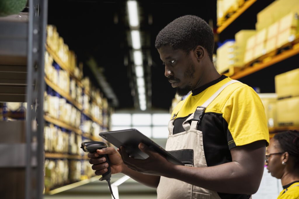 Fulfillment Center Worker Scanning Shipping Labels To Register In Inventory